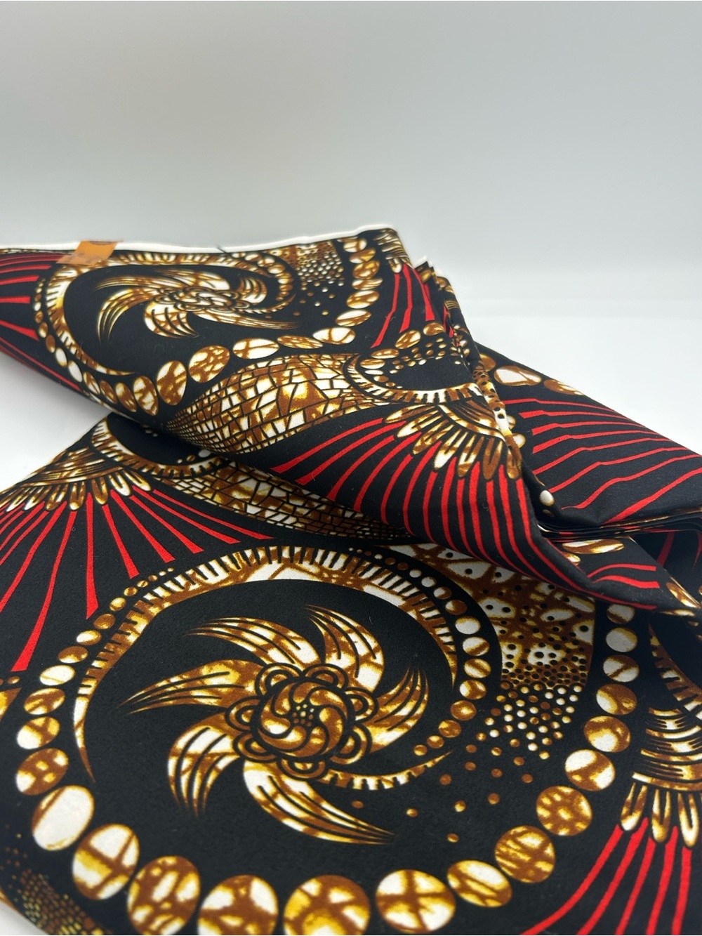 Bold print African Wax Fabric with black, brown, white and red pattern. 6 yards